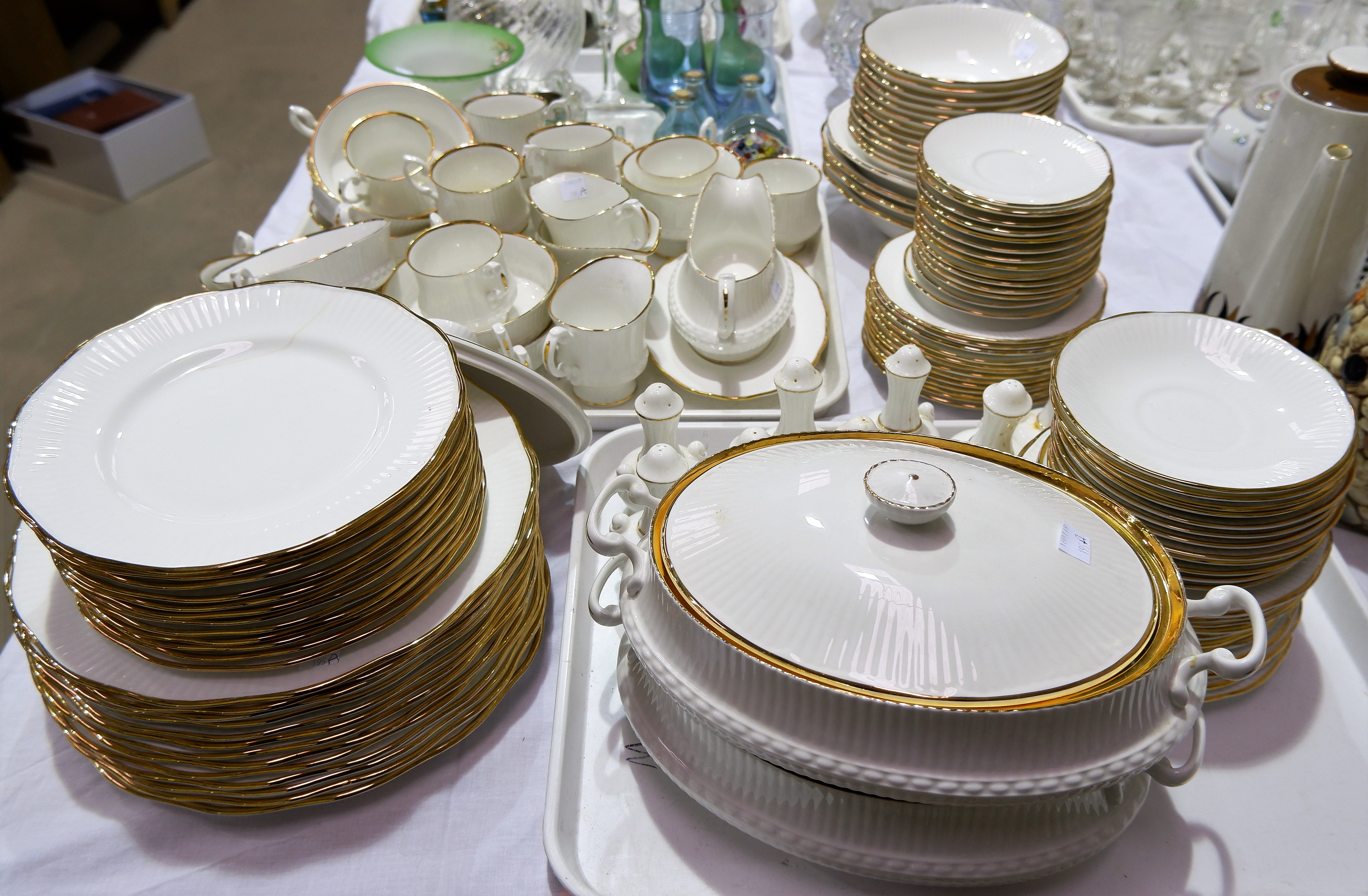 A Sandringham bone china part dinner and tea service with gilt rim and ribbed decoration