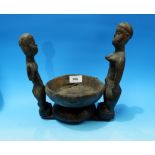 An African tribal group male and female figures and bowl, length 10"