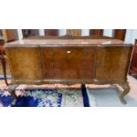 A carved burr walnut sideboard in the manner of Epstein, comprising 2 cupboards and 3 drawers, on