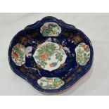 A quatrefoil Chinese shell dish, the reserve panels decorated with flowers and leaves in