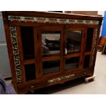 A large, heavy stained wood Arts and Crafts style display cabinet with double glazed doors, inlaid