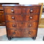 A Victorian mahogany bow front chest of drawers, with two short drawers and three long, on turned