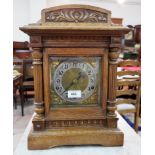 An early 20th century mantel clock in oak case with fluted side columns, 3 train chiming movement,