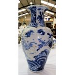 A 19th century Chinese large blue and white baluster vase decorated with dragons in relief, and