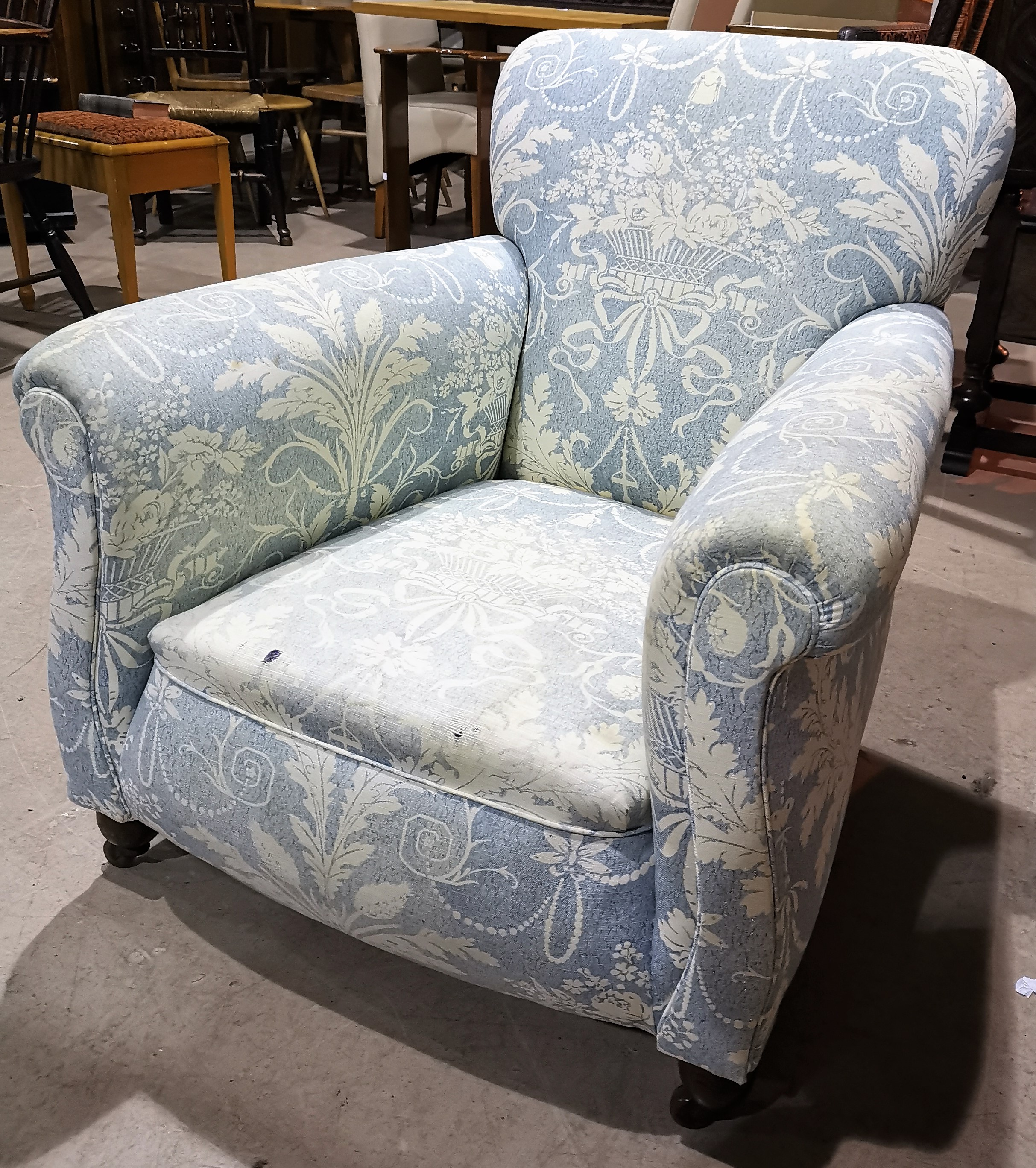 An Edwardian lady's arm chair upholstered in traditional blue cotton fabric