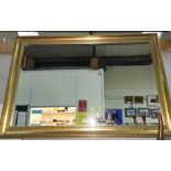 A large rectangular wall mirror with bevelled edge in gilt frame
