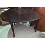 An 18th century Cuban mahogany dining table, oval top and drop leaf, on pad feet