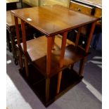 A reproduction revolving bookcase in crossbanded yew wood; a similar coffee table