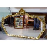 A large wall mirror in rectangular gilt frame; an overmantel mirror in Venetian style ornate