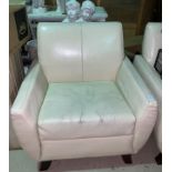 A pair of cream leather effect armchairs