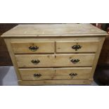 A stripped pine chest of 2 short and 2 long drawers
