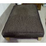 A large rectangular footstool in mottled black/gold fabric