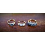 A gold dress ring set with five oval opals, stamped 375 and two gilt dress rings