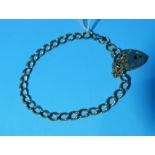 A 9 carat hallmarked gold curb chain bracelet with heart lock