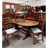 An oval oak extending dining table with interior leaf, a set of six dining chairs and two