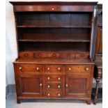An 18th century Welsh dresser with raised back, moulded cornice, 2 shelves over 5 small drawers, the