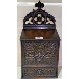 A carved and stained wood candle box in the Gothic style, with lower drawer, 17"