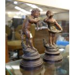 A pair of French figures of children, patinated and bronzed, on turned ebonised bases, signed,