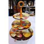 A 1960's Italian majolica 3 tier cake stand, turned wood supports, with tripod base, height 21"