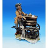 A Capodimonte group: barrel organ player with dog, height 11½"
