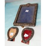 An embossed silver rectangular photo frame; 2 small heart shaped photo frames