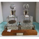 A pair of small cut glass decanters with silver rims and bottle labels 'Port' & 'Whisky', on