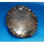 A hallmarked silver large scalloped salver, inscribed, 35 oz.