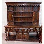 An early/mid-18th century oak country made high dresser, the raised back with moulded cornice and