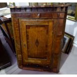 A Georgian mahogany and oak crossbanded corner cupboard with three draws bellow (veneer a.f)