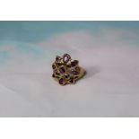A 9 carat gold dress ring with purple stones in openwork setting