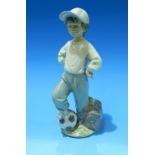 A Lladro figure: boy with football, made for Rotary International