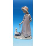 A Lladro group, girl pulling doll in cart, 11"