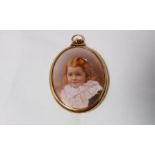 An 18 carat gold framed pendant with miniature of a child to each side, London 1898