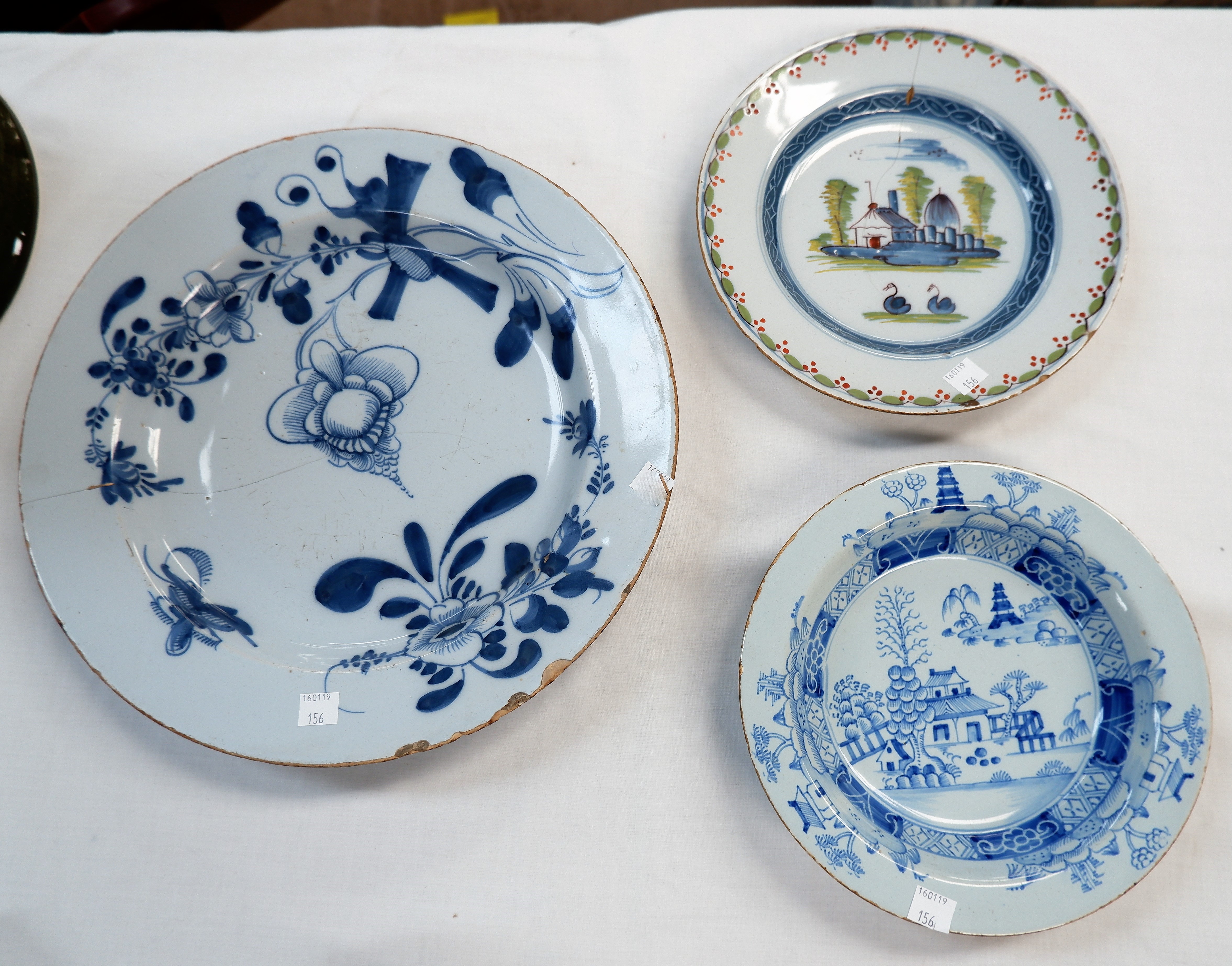 An 18th century Delft large blue & white circular dish (cracked and border fritted); a similar