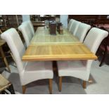 A heavy modern light oak extending dining table with 2 additional leaves and 6 cream leather