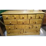 A modern pine chest of 12 small drawers