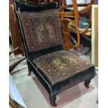 A late 19th early 20th century tapestry nursing chair with turned legs