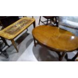 A reproduction oval coffee table, quarter veneered, on turned fluted legs; a similar Italian