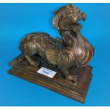 A 19th century Chinese bronze depicting a mythical beast with dog of fo head and dragon legs with