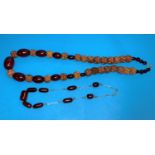 A cherry amber coloured Bakelite and wooden graduating beaded necklace, largest bead 25mm; another