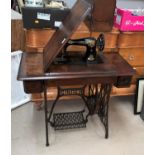 A Singer treadle sewing machine in mahogany case