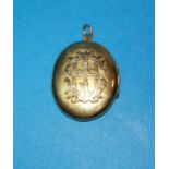 A yellow metal monogrammed locket, unmarked, tests as 14c, gross weight 19.5gm
