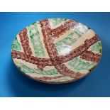 A 19th / early 20th century Middle Eastern terracotta bowl with green / brown mottled decoartion