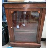 A Victorian rosewood display cabinet with inlaid decoration enclosed by single glazed door