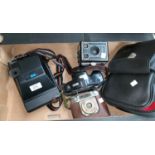 A Kodak EK160-EF Instant camera; a German camera; a box Brownie; a Nikai-TEC