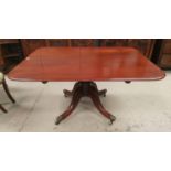 A late Georgian mahogany supper table with rounded rectangular tilt top, on turned central column
