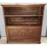 A Macclesfield carved oak 2-height bookcase with fall front cupboard under