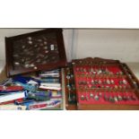 A collection of silver spoons, loose and on wall shelves