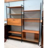 A 1960's teak Ladderax unit comprising a drop front cabinet, another sliding door unit, shelves and