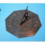 An early 20th century octagonal brass sundial, engraved numerals and compass points, 8"